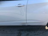 a white car that has a broken door handle on it