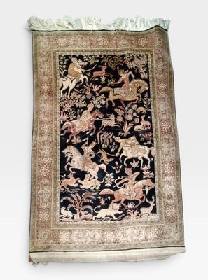an oriental rug with animals and flowers on a black ground