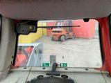 a view of a forklift from inside of a vehicle