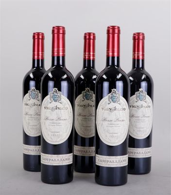 four bottles of wine are lined up on a table