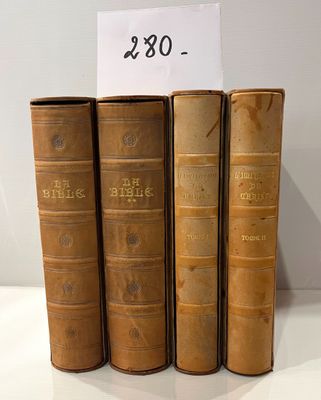 three old books are stacked on top of each other on a table
