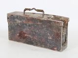 an old metal box with a handle on a white surface