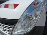 a white van that has a red and white stripe on it