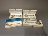 four silverware items are in a box on a table