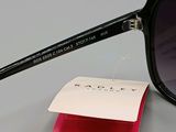 black sunglasses with a pink case and a white tag on a gray surface