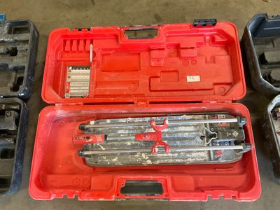 a red tool box with tools in it on the floor