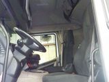 a white van with a black seat and a suitcase in the back