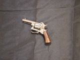 a gun that is laying on a blanket on the floor