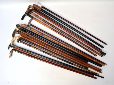 six wooden canes are lined up in a row on a white surface