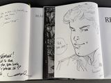 an open book with a drawing of a man on it