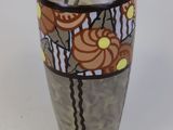 a vase that is sitting on a white surface
