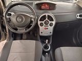 a dashboard of a small car with a digital clock on it