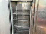 an open refrigerator that is sitting inside of a building