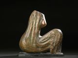 bronze sculpture of a woman sitting on a black surface