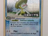 une photo d'une carte Pokémon sur laquelle figure le portrait d'une personne