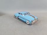 a blue toy car that is sitting on a table