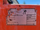 a label on the back of an orange machine