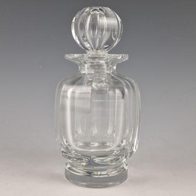 a clear glass perfume bottle with a glass stopper on the top