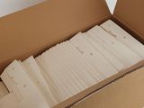 a cardboard box that has a bunch of papers in it