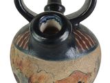 a small vase with a handle on it on a white background