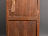 an old wooden cabinet with two drawers and a door