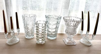 five glasses and a candle holder on a table