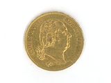 a close up of a gold coin on a white surface
