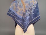 a close up of a blue scarf on a mannequin head