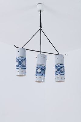 three blue and white vases hanging from the ceiling