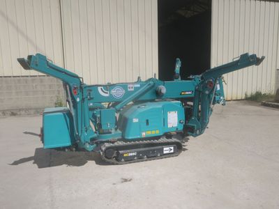 an image of a blue machine parked in front of a building