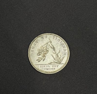 a close up of a coin on a black surface