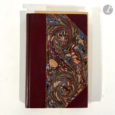 a red book with a design on it on a white surface