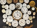 many different types of pocket watches on the table