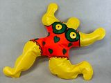 a stuffed frog that is laying down on the floor