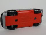 a red and black toy train on a white surface