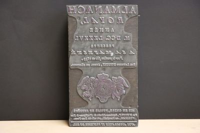 un gros plan sur une plaque posée sur une table, sur fond noir