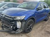 the front end of a blue volkswagen suv that has been badly damaged