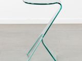 a glass side table with a curved glass top