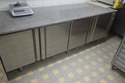 a small kitchen with a scale on the counter