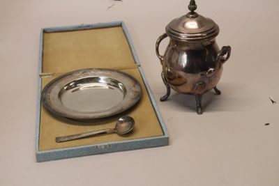 a silver tea pot and a silver plate in a box