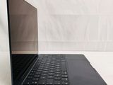 a black laptop with a black keyboard on a white surface