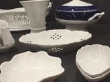 many white dishes and bowls sitting on a table