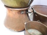 pots and pans are sitting on a white surface next to each other