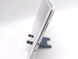 a tablet computer sitting on a stand on a white surface