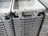 several plastic containers stacked on top of each other on a pallet