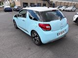 a small blue car parked in a parking lot