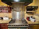 a kitchen with a stove, oven, and microwave in it