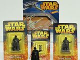 three star wars action figures sit in front of each other