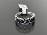 a close up of a ring on a table with a tag