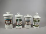 three white ceramic containers with different designs on them sitting on a table